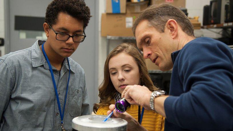 Dr. Jeffrey Calcaterra (right), Structural Failure Analysis team lead for Air Force Research Laboratory Materials Integrity Branch, explains nondestructive inspection processes to (from left) Tristan Gilreath and Alexa Gebhardt, area high school students who were attending a job Shadow Day at Wright-Patterson Air Force Base Oct. 27. The bi-annual event, put on by the Air Force Research Laboratory’s Educational Outreach Office, is designed for students to experience on the job real-life experiences and allow them to explore potential career field opportunities. (U.S. Air Force photo/Jim Varhegyi)