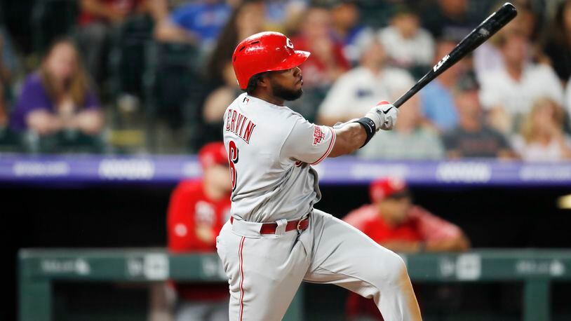 Cincinnati Reds' Phillip Ervin watches his RBI triple off Colorado Rockies starting pitcher Kyle Freeland during the third inning of a baseball game Saturday, July 13, 2019, in Denver. (AP Photo/David Zalubowski)