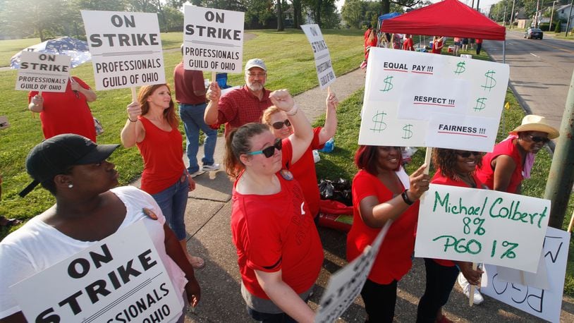 Members of the Professionals Guild of Ohio, which represents about 270 Montgomery County Children Services positions, picket outside the Haines Children’s Center on the first day of a strike Friday. CHRIS STEWART / STAFF