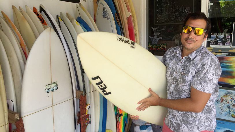 César Rueda holds a board outside his Stop and Go Surf Market in Playa Colorado, Nicaragua, which he says has ‘an amazing beach break, a world-class wave.’ But unrest in Nicaragua has been a hard blow to tourism, he adds. (Tim Johnson/McClatchy Washington Bureau/TNS)