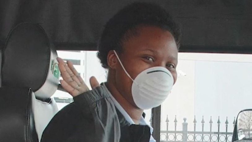 RTA fixed-route driver, Alexis Appleberry, welcomes riders onto the bus with a smile and a face mask on.