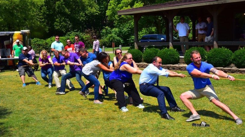 Financial management and contracting interns battle it out with program management interns in a friendly challenge of tug of war at the inaugural Wright-Patterson Air Force Base picnic held at Bass Lake Aug. 10. The PM interns were victorious. (U.S. Air Force photo/Alex Feuling)