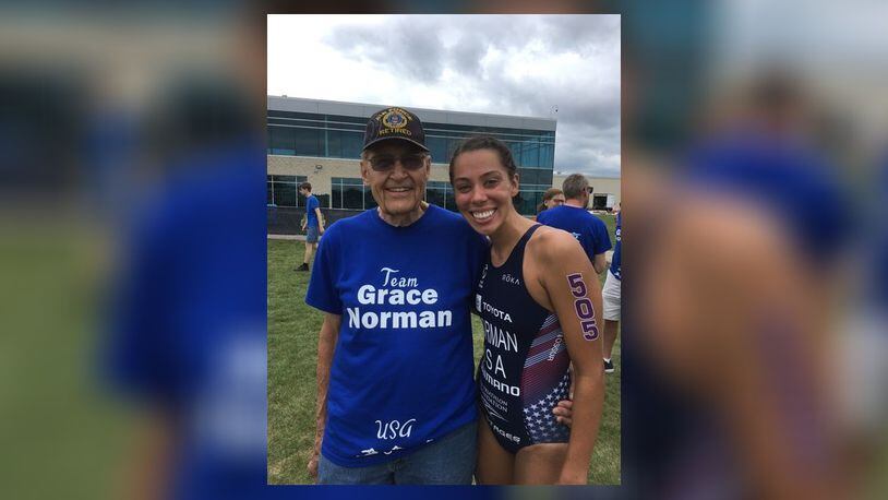 Grace Norman – pictured here with her grandfather – was surprised by her family at the Americas Triathlon Para Championships in Pleasant Prairie, Wisconsin on June 27.  The group all wore Grace Norman t-shirts. She won in Wisconsin and that put her on the US Paralympic team for the 2021 Tokyo Games which begin in August. She is the defending gold medal winner, having won the paratriathlon PT4 class (now renamed the PTS5 category) in Rio de Janeiro Brazil in 2016. CONTRIBUTED