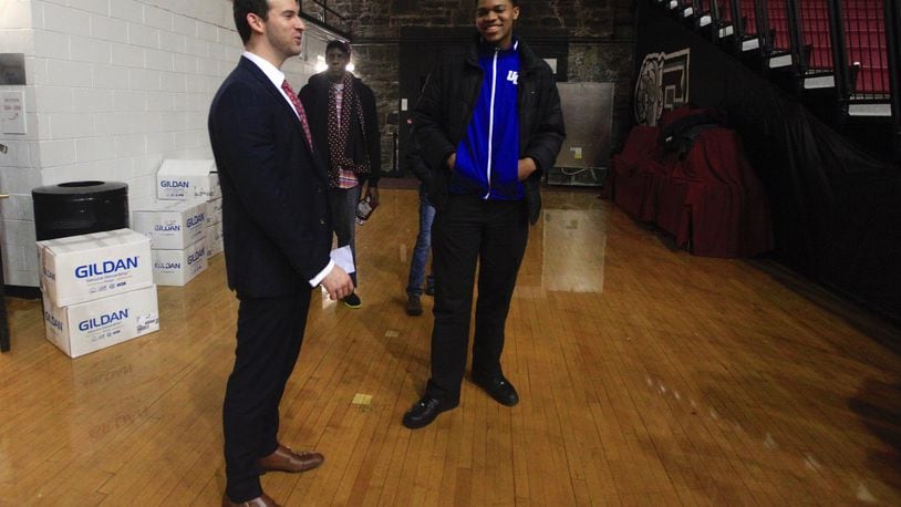 Dayton coach Brian Frank, left, talks with 2017 UD recruit Jordan Pierce after a victory against Fordham on Tuesday, Jan. 31, 2017, at Rose Hill Gym in Bronx, N.Y. David Jablonski/Staff