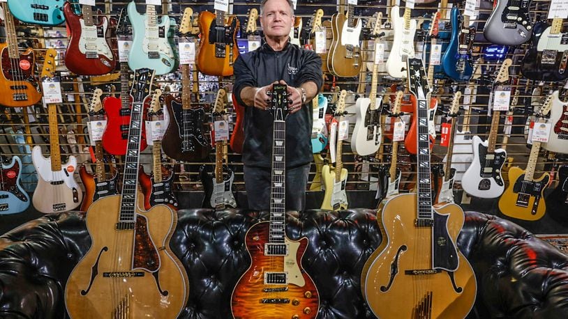 Hauer Music president, Jim Hauer show-off three of his stores most expensive guitars. Hauer Music is celebrating 85 years in the Dayton area. Many famous and not so famous musicians have walked through the doors. The store is located at 528 Miamisburg-Centerville Road in Centerville. JIM NOELKER/STAFF
