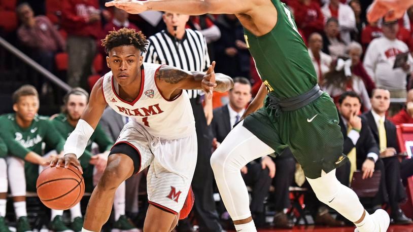 Miami’s Nike Sibande dribbles under Wright State’s Mark Hughes during their game Tuesday, Nov. 14, 2017, at Millett Hall in Oxford. NICK GRAHAM/STAFF