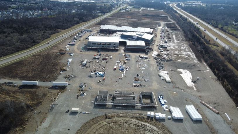 Fairborn plans to repave Commerce Center Boulevard (left), site of the new Fairborn High School now under construction near I-675 (right). CONTRIBUTED