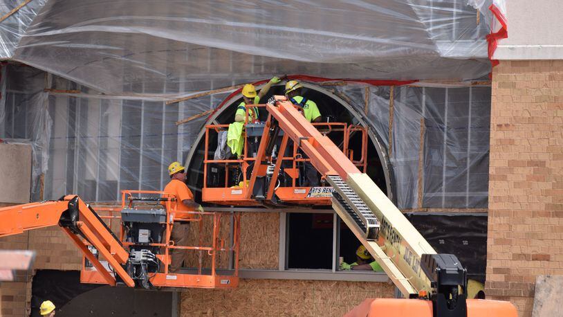 New Cutline: Dozens of stores have closed in the Dayton area over the past year, but area experts said the market is still healthy because the area is filling those locations. Danis construction works on the Sears box at the Mall at Fairfield Commons. STAFF PHOTO / HOLLY SHIVELY