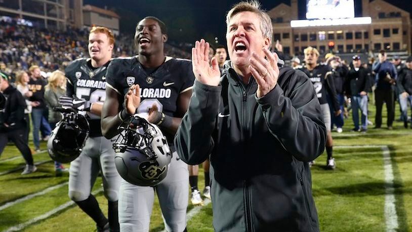 Colorado Buffaloes coach Mike MacIntyre sings the school song with players in the second half of an NCAA college football game Saturday, Nov. 19, 2016, in Boulder, Colo. Colorado won 38-24. (AP Photo/David Zalubowski)