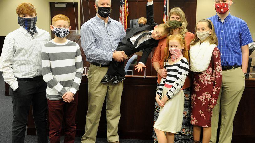 The Adkins family of Tipp City added a new family member during National Adoption Day proceedings in Montgomery County Probate Court  Friday, November 20, 2020. Pictured from left to right, Isaiah, 17, Silas,12, father Randy, Judge Alice O. McCollum, Warren, 3, mother Priscilla, Lydia, 9, Sarah, 14 and Nathaniel, 19. MARSHALL GORBY\STAFF