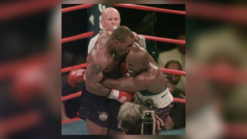 FILE - This June 28, 1997, file photo shows Mike Tyson biting into the ear of Evander Holyfield in the third round of their WBA heavyweight match in Las Vegas. Violence is part of the game in many sports. But when the Clevelandâ€™s Myles Garrett ripped the helmet off Mason Rudolph and hit the Pittsburgh Steelersâ€™ quarterback in the head with it, the Brownsâ€™ defender crossed a line _ one that attracts the attention of authorities sometimes from within their sport and in other cases from criminal prosecutors.(AP Photo/Jack Smith, File)