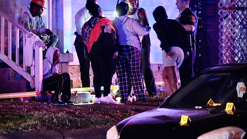 Residents are shown at the scene of mass shooting Sunday morning May 1, 2022. One person was fatally shot and four others were transported to hospitals with gunshot wounds.  MARSHALL GORBY \STAFF