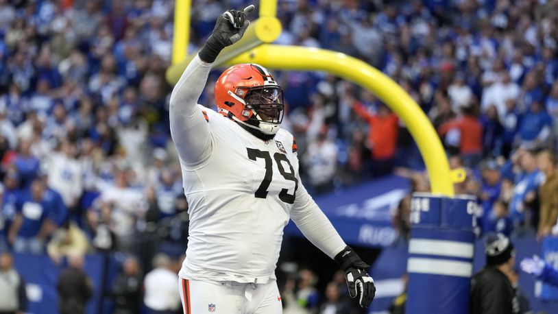 Cleveland Browns offensive tackle Dawand Jones (79) celebrates after a touchdown by teammate Kareem Hunt during the second half of an NFL football game against the Indianapolis Colts, Sunday, Oct. 22, 2023, in Indianapolis. The Browns won 39-38. (AP Photo/Michael Conroy)