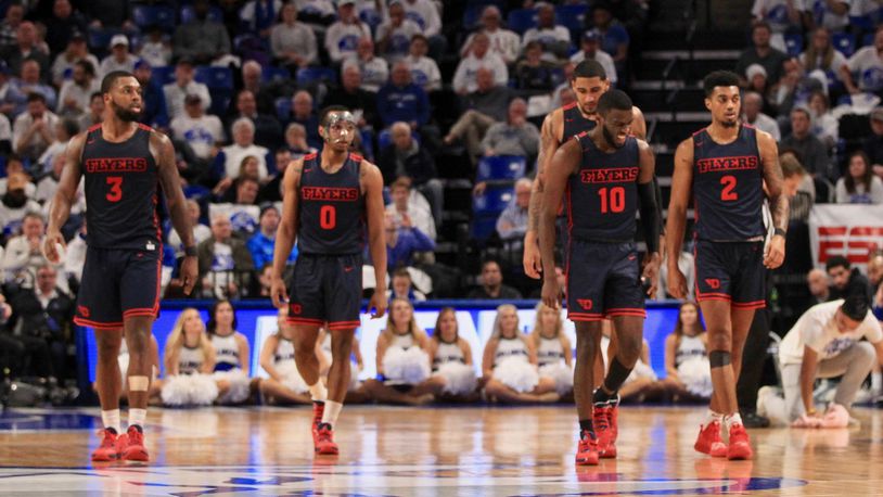 Dayton players head to a huddle during a timeout against Saint Louis on Friday, Jan. 17, 2020, at Chaifetz Arena in St. Louis, Mo. David Jablonski/Staff