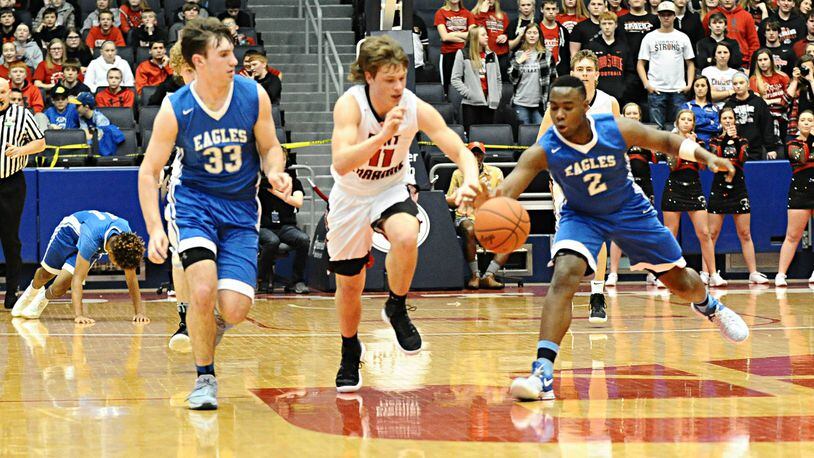 Middletown Christian’s Jarod Hamlin (33) and Dre Shores (2) battle Fort Loramie’s Nick Brandewie (11) for the ball during Friday night’s Division IV district final at the University of Dayton Arena. CONTRIBUTED PHOTO