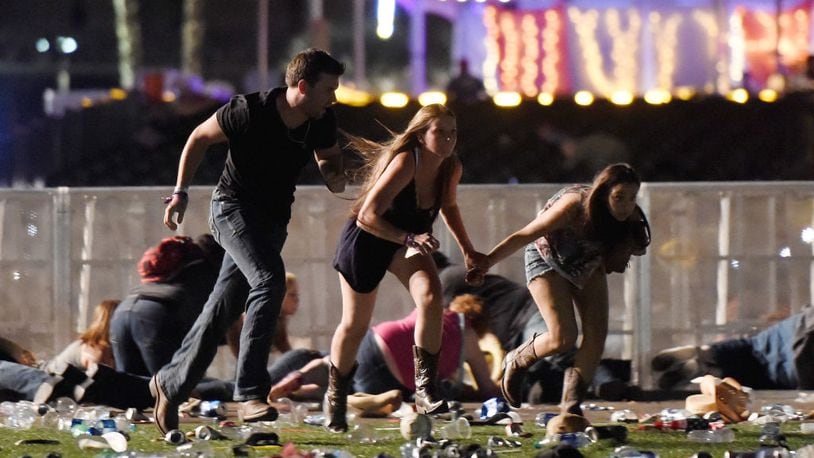 People run from the Route 91 Harvest country music festival after shots were fired on Oct. 1 in Las Vegas.