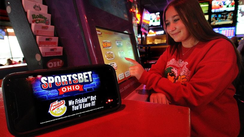 Lily Spahr sits at a gaming kiosk at the Fricker's in Centerville Wednesday Dec. 28, 2022. The Ohio Legislature passed a sports betting bill in December, 2021, and the Ohio Casino Control Commission announced in June of 2022 that it would launch sports gambling Jan. 1, 2023. MARSHALL GORBY\STAFF