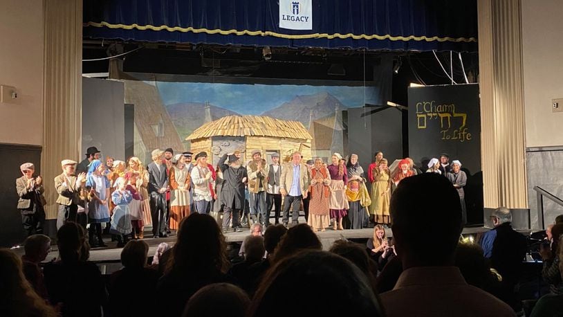 Ken Kettering with the cast on stage at Legacy Christian in Xenia for "Fiddler on the Roof" on April 22. CONTRIBUTED