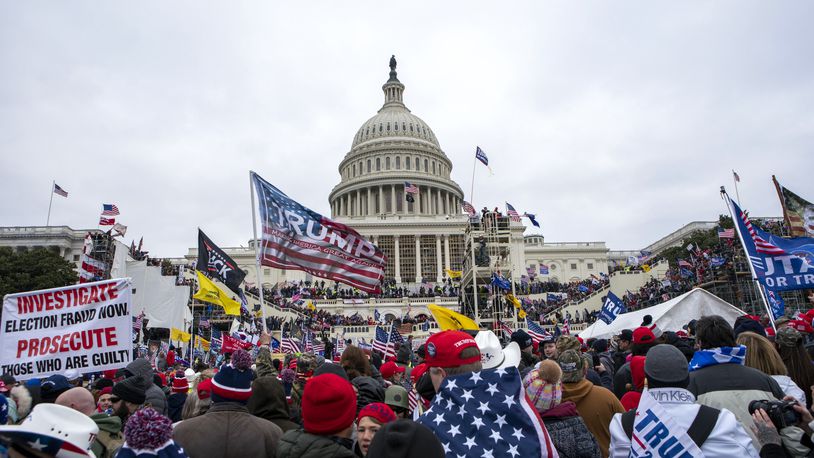 FILE - Rioters loyal to President Donald Trump rally at the U.S. Capitol in Washington on Jan. 6, 2021. The FBI arrested three Florida residents on Saturday, Jan. 6, 2024, the third anniversary of their alleged attack on Capitol police officers during the Jan. 6, 2021, insurrection. (AP Photo/Jose Luis Magana, File)