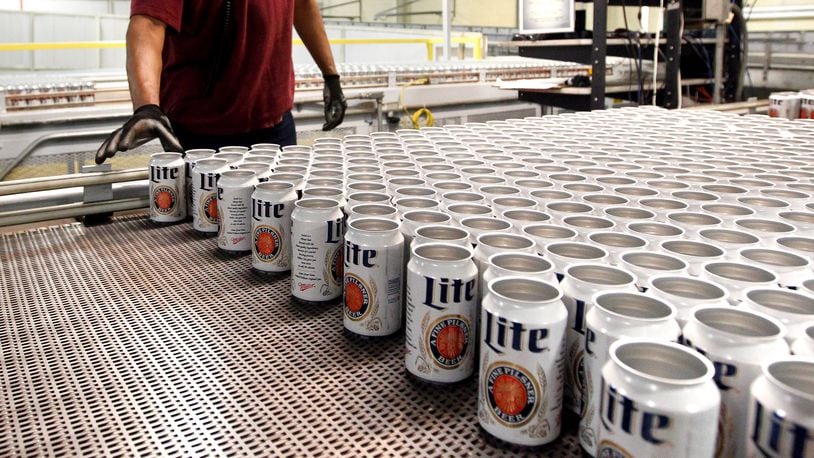 MillerCoors production technician, Lionrick Bolar, moves Miller Lite cans to be filled on the line in a file photo from the MillerCoors Brewery in Trenton.