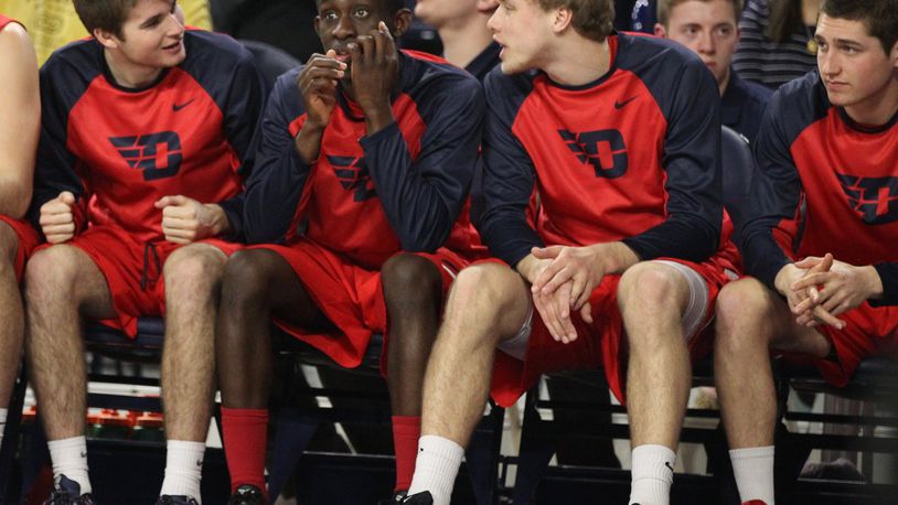Dayton players (left to right: Joey Gruden, Jeremiah Bonsu, Michael Schwieterman and Jack Westerfield) watch from the bench during a game against Richmond on Tuesday, March 1, 2016, at the Robins Center in Richmond, Va. David Jablonski/Staff