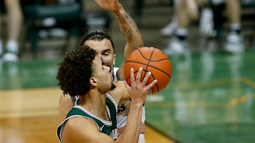 Wright State guard Tanner Holden tries to shoot on Cleveland State guard Tre Gomillion during a Horizon League game at the Nutter Center in Fairborn Jan. 16, 2021. Wright State won 85-49. Contributed photo by E.L. Hubbard