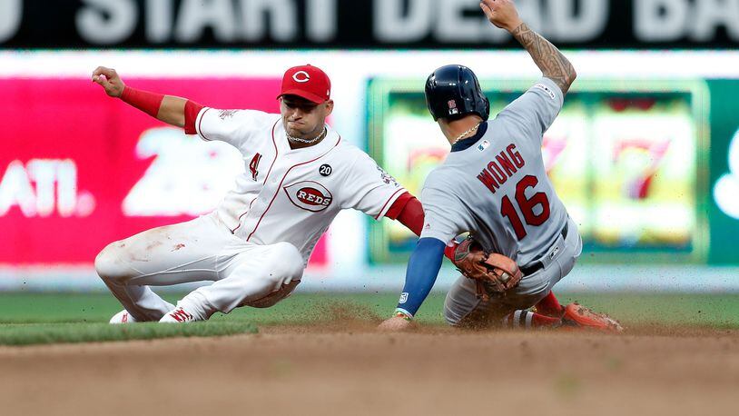 CINCINNATI, OH - JULY  18:  Kolten Wong #16 of the St. Louis Cardinals beats the throw to Jose Iglesias #4 of the Cincinnati Reds at second base during the fifth inning at Great American Ball Park on July 18, 2019 in Cincinnati, Ohio. St. Louis defeated Cincinnati 7-4. (Photo by Kirk Irwin/Getty Images)