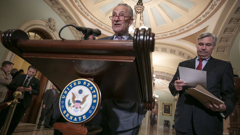 Senate Minority Leader Chuck Schumer, D-N.Y., joined at right by Sen. Sheldon Whitehouse, D-R.I., says Senate Democrats will initiate a federal lawsuit if their requests for documents from Brett Kavanaugh’s days as a White House aide are denied, during a news conference on Capitol Hill in Washington, Thursday, Aug. 16, 2018. (AP Photo/J. Scott Applewhite)
