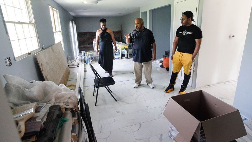 Due to insurance and contractor problems, Kandace and Derrick Stephens, pictured with their son Darius, are still waiting to move back into their Greenbrook Drive home in Trotwood two years after 2019 Memorial Day tornadoes hit the region. CHRIS STEWART / STAFF