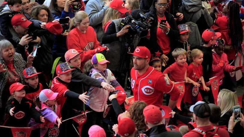 Joey Votto, of the Cincinnati Reds, walks the red carpet on Kids Day at Great American Ball Park on Saturday, March 30, 2019, in Cincinnati.