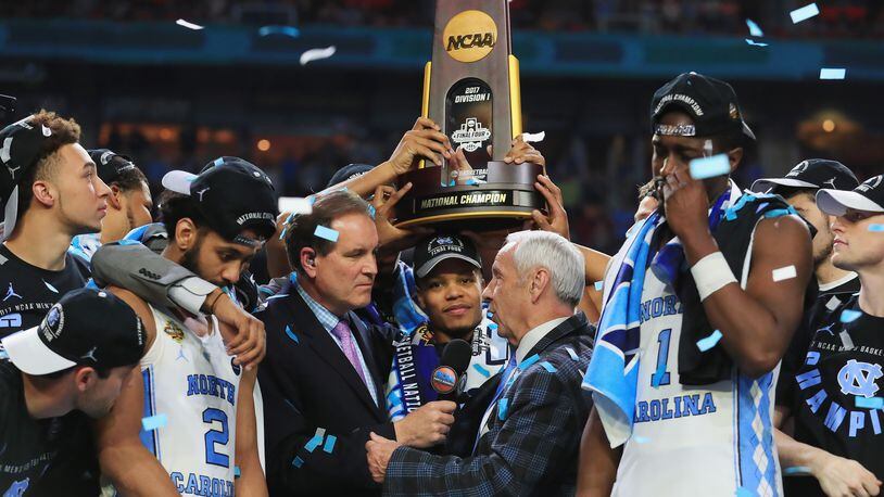 GLENDALE, AZ - APRIL 03:  TV personality Jim Nantz speaks to head coach Roy Williams of the North Carolina Tar Heels and his team after defeating the Gonzaga Bulldogs during the 2017 NCAA Men's Final Four National Championship game at University of Phoenix Stadium on April 3, 2017 in Glendale, Arizona. The Tar Heels defeated the Bulldogs 71-65.  (Photo by Tom Pennington/Getty Images)