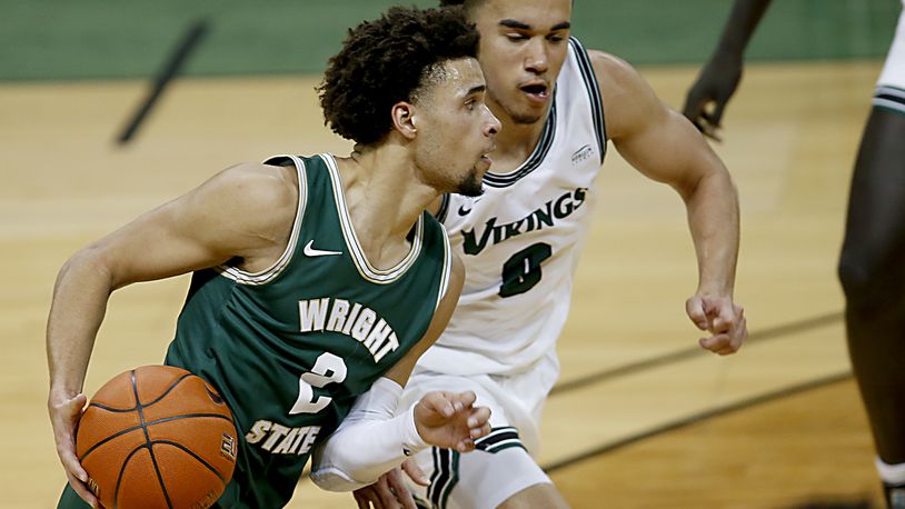 Wright State guard Tanner Holden is covered by Cleveland State guard Alec Oglesby during a Horizon League game at the Nutter Center in Fairborn Jan. 16, 2021. Wright State won . Contributed photo by E.L. Hubbard