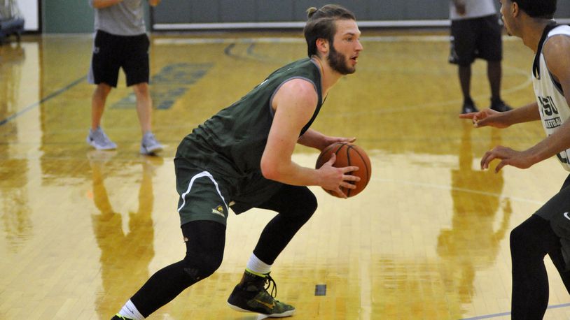Wright State sophomore Bill Wampler looks for a driving lane against freshman James Manns during summer practice Thursday at the Stelzer Pavilion. STAFF FILE