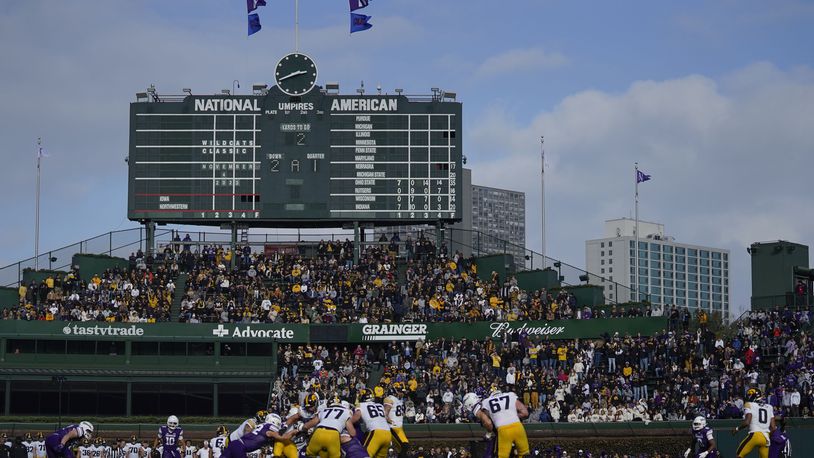 Fans watch the first half of an NCAA college football game between Iowa and Northwestern, Saturday, Nov. 4, 2023, at Wrigley Field in Chicago. (AP Photo/Erin Hooley)
