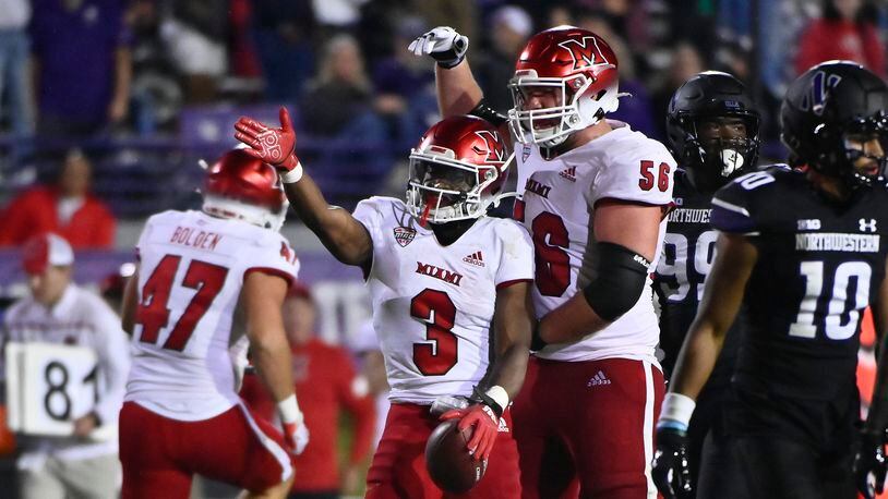 Miami (Ohio) running back Keyon Mozee (3) and offensive lineman Reid Holskey (56) signal during the second half of the team's NCAA college football game against Northwestern, Saturday, Sept. 24, 2022, in Evanston, Ill. (AP Photo/Matt Marton)