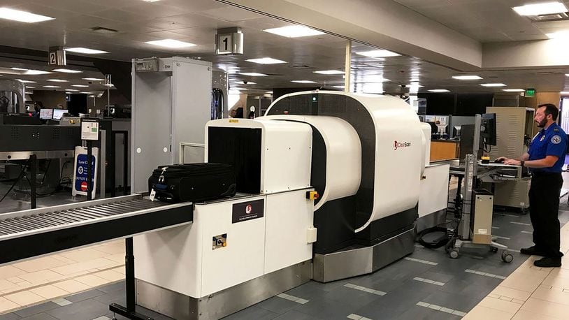 An agent uses a new computed tomography scanner at Phoenix Sky Harbor International Airport. The Transportation Security Administration has announced it plans to test 15 new CT scanners in the next few months. (TSA/TNS)