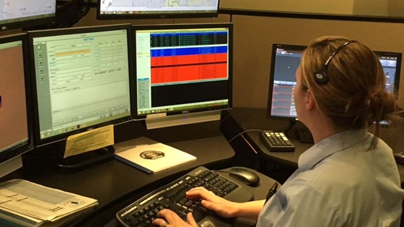 Amanda Holland works in the Centerville Police Department s dispatch center, which handles emergency calls for the city of West Carrollton. The Miami Valley Communications Council is looking to further joint efforts among its members by implementing a fiber ring. NICK BLIZZARD/STAFF PHOTO