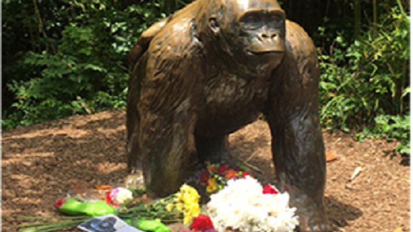 A makeshift memorial for Harambe was building Sunday May 29, 2016 around a bronze statue of a gorilla at the Cincinnati Zoo & Botanical Garden. (Contributed)