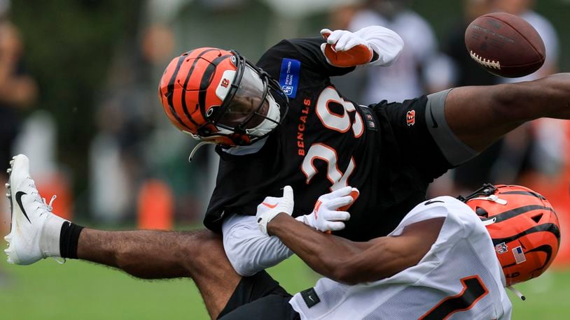 Cincinnati Bengals' Kendric Pryor, bottom, attempts a catch against Cam Taylor-Britt during the NFL football team's training camp in Cincinnati, Wednesday, July 27, 2022. (AP Photo/Aaron Doster)