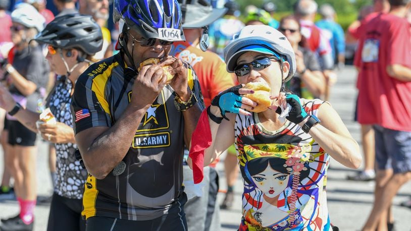 Participants in the 2019 Tour de Donut in Troy indulge in the event's namesake. CONTRIBUTED