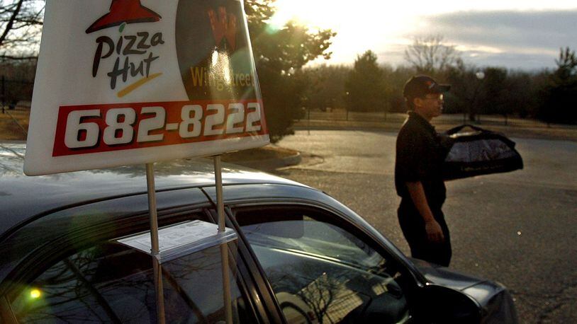 Pizza Hut and Toyota are teaming up to begin testing self-driving pizza cars as soon as 2020. (Larry Smith/Wichita Eagle/TNS)