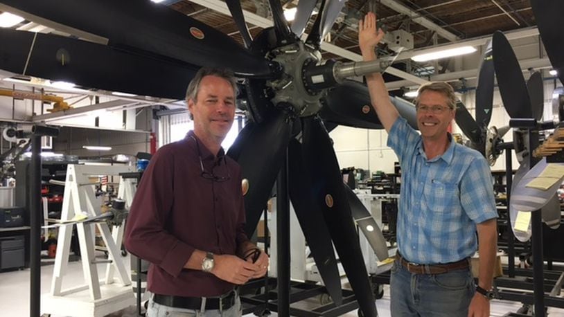 James Brown, left, Hartzell Propeller Inc., executive vice president, and Joseph Brown, Hartzell president, stand next to the largest propeller the Piqua company still maintains. THOMAS GNAU/STAFF