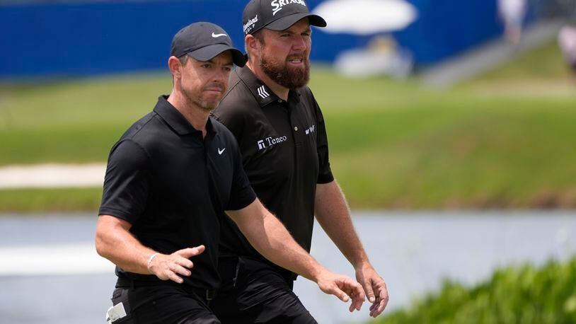 Rory McIlroy, of Northern Ireland, acknowledges the crowd as he walks onto the ninth green with teammate Shane Lowry, of Ireland, during the second round of the PGA Zurich Classic golf tournament at TPC Louisiana in Avondale, La., Friday, April 26, 2024. (AP Photo/Gerald Herbert)