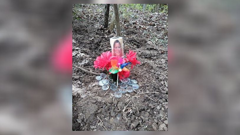A memorial has been placed at the spot where the remains of Cheryl Coker were found Saturday evening./ CONTRIBUTED