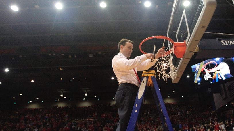 Dayton's Archie Miller cuts down the net after a victory against Virginia Commonwealth on March 1, 2017, at UD Arena.