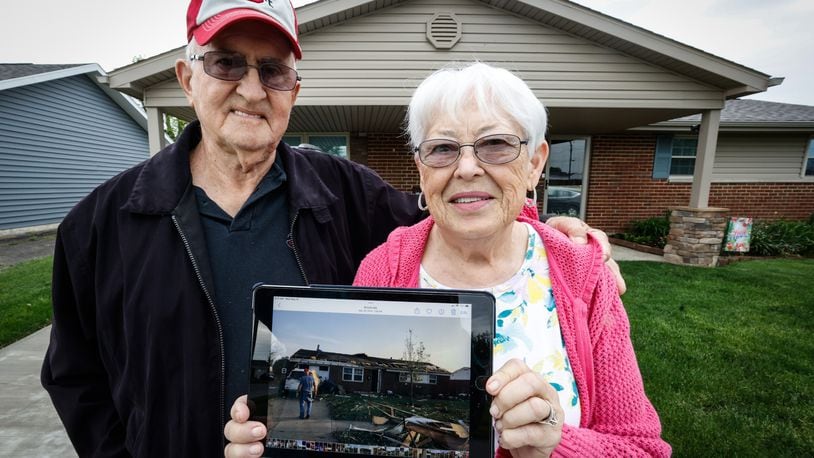 John and Shirley Behm stand in front of their house in Brookville that was damaged by the Memorial Day tornados three years ago. JIM NOELKER/STAFF