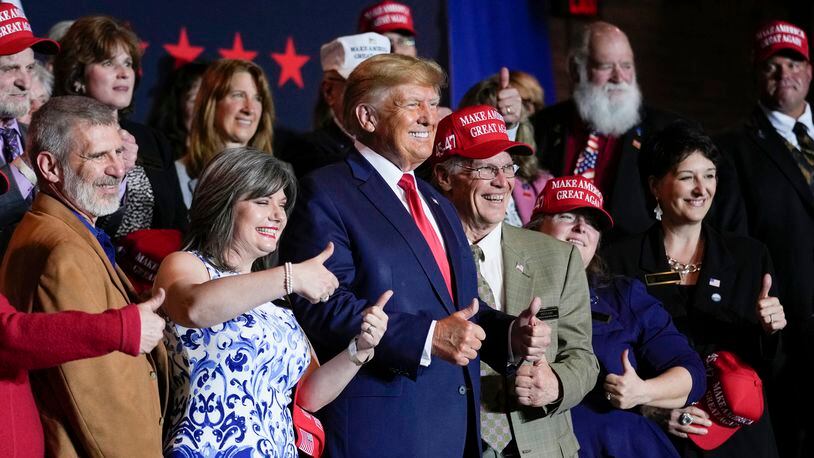 FILE - Former President Donald Trump poses for a photo with supporters after speaking at a campaign event Thursday, April 27, 2023, in Manchester, N.H. He's a criminal defendant, a businessman and a politician. But to his most loyal supporters, Donald Trump will always be Mr. President. When it comes to signaling our political loyalities, language can be just as telling as a MAGA cap, offering a simple by subtle reminder of the false election claims that continue to reverberate online, as well as the polarization that has gripped our politics and divided our people. (AP Photo/Charles Krupa, File)