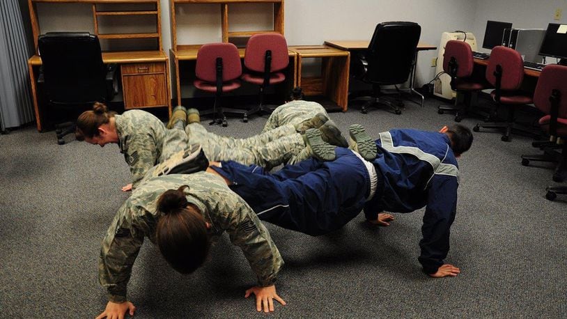 Airmen from the 445th Maintenance Operations Squadron do the four-man push-up to demonstrate the physical fitness domain in the Comprehensive Airman Fitness. Wright-Patterson Air Force Base organizations are getting ready for Wingman Day on Oct. 4. (Contributed photo)