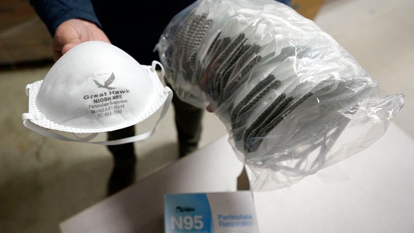 Grocery stores and pharmacies in the Dayton area are giving away free N95 masks as part of a federal program. (AP Photo/Charles Krupa)