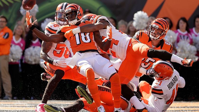 CINCINNATI, OH - OCTOBER 23: A.J. Green #18 of the Cincinnati Bengals catches a hail marry pass for a touchdown at the end of the second quarter of the game while being defended by Ibraheim Campbell #24 of the Cleveland Browns at Paul Brown Stadium on October 23, 2016 in Cincinnati, Ohio. (Photo by Andy Lyons/Getty Images)